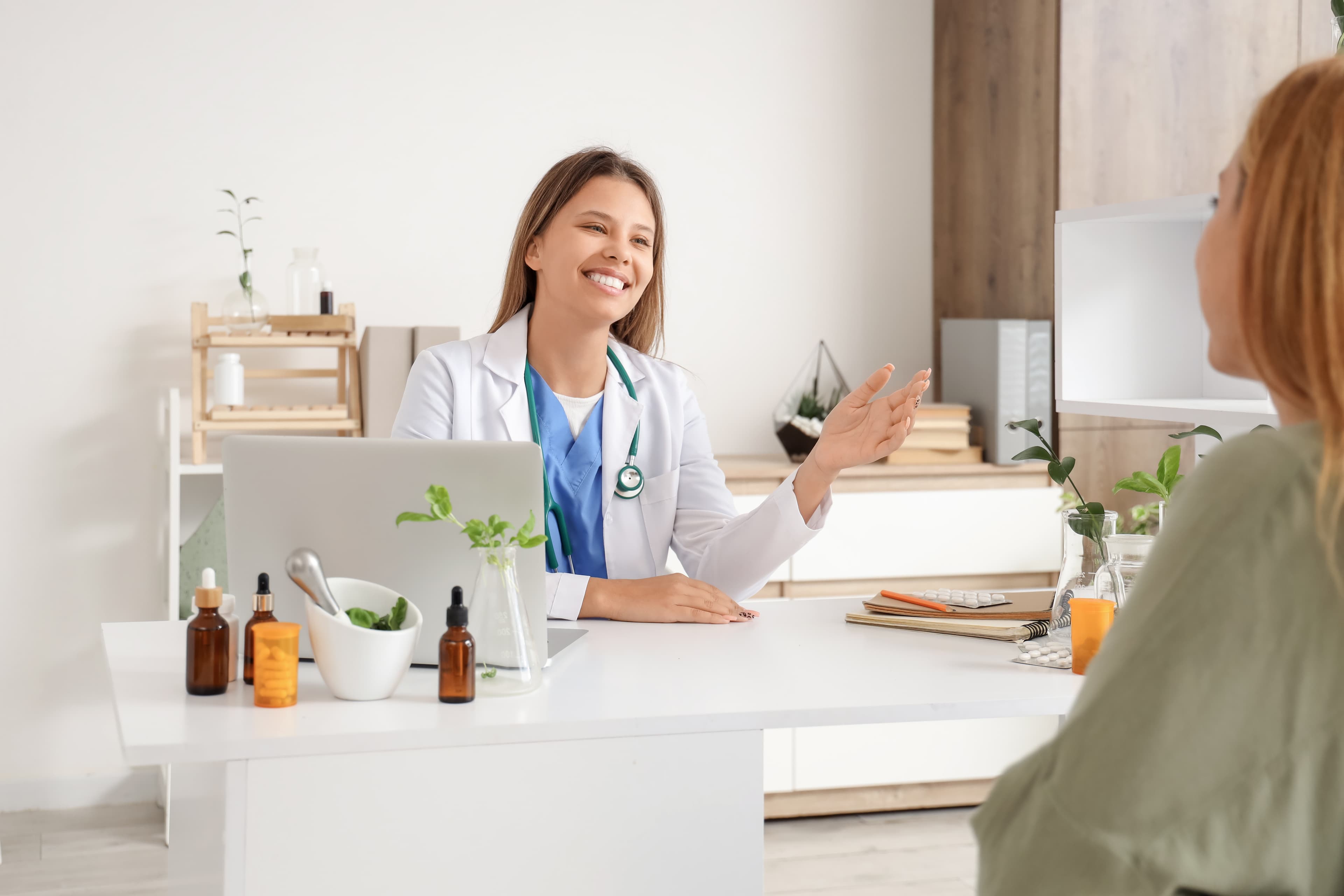 Herbal consultation workspace with dried herbs and notes