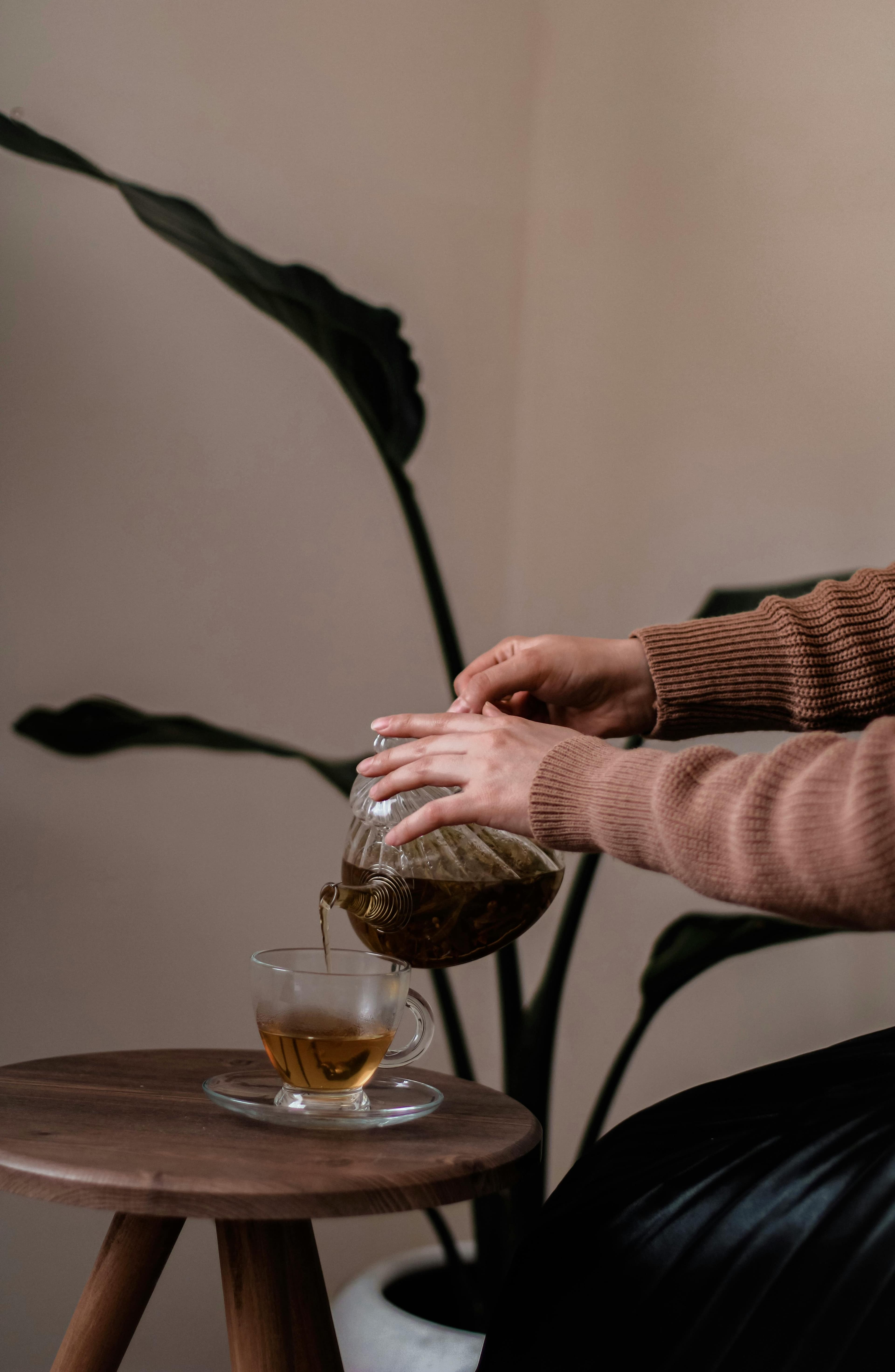 Pouring freshly brewed herbal tea