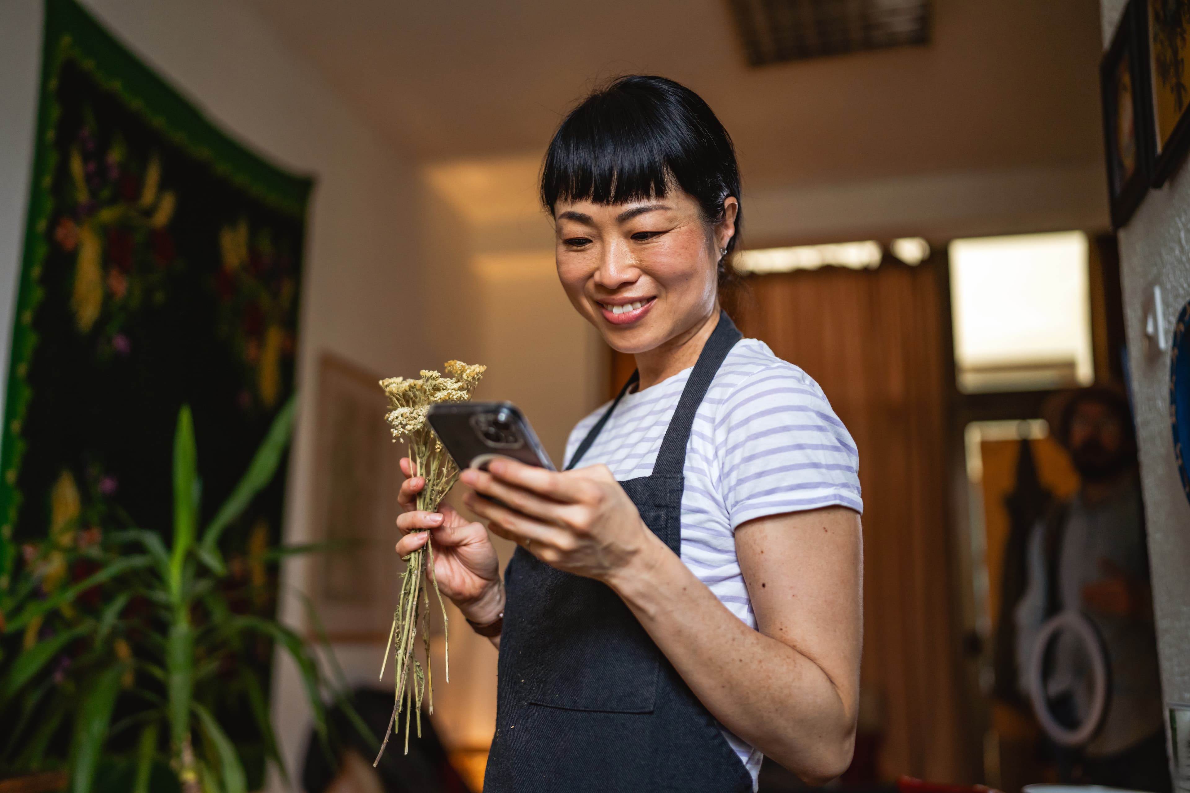 Practitioner reviewing herbal protocols on a mobile device